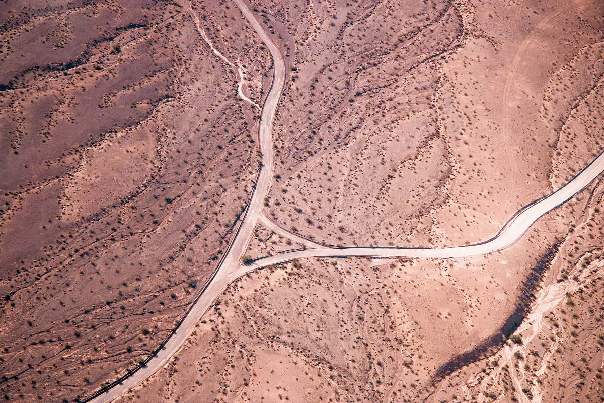 aerial view aerial photo of road on desert during daytime grand canyon village